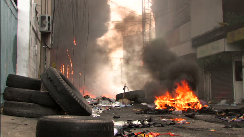 Burning street after riot conflict protest with police.