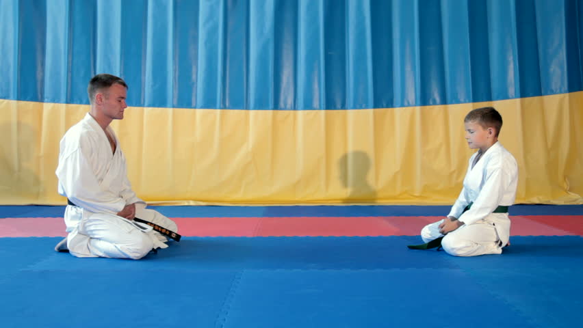 Boy learning from his karate instructor