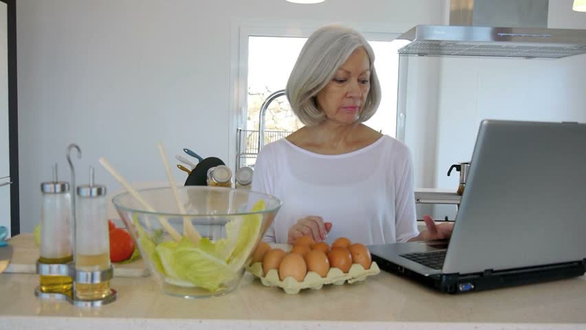 Senior woman checking cooking recipe on internet