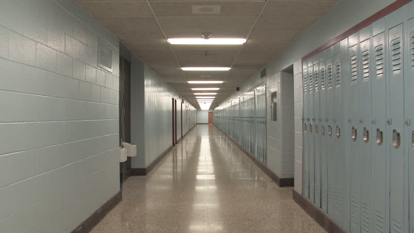 High school hallway. Slow zoom.  Slow zoom down a long, empty high school hallway. Lockers lining the right wall. Shot with Canon XH-A1s. 