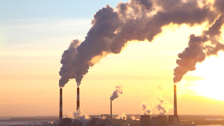Smoke from pipe of thermal power station in winter sunset