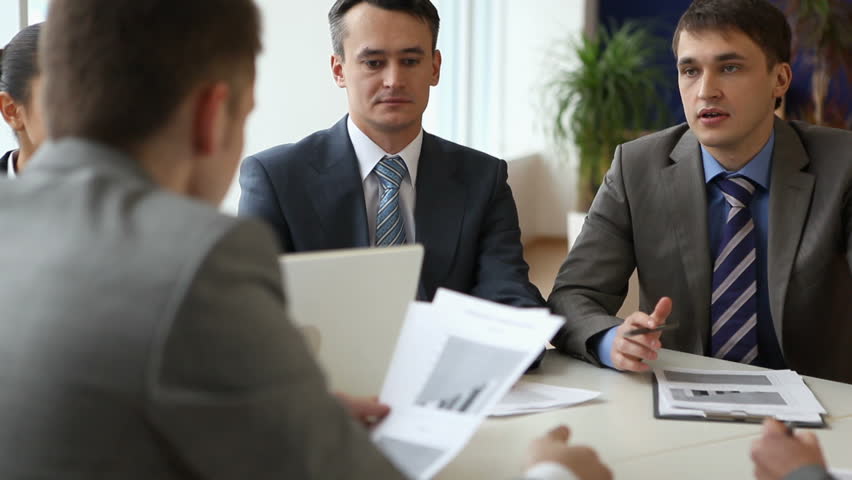 Businesspeople sitting at the boardroom and discussing business-plan