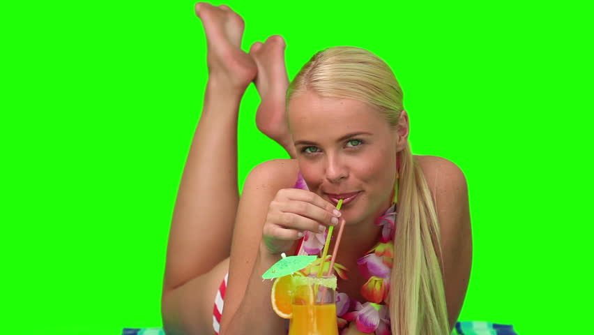 Chromakey footage of a wonderful blond woman on the beach sipping a cocktail