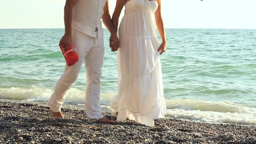 First In The Frame The Black Sea, Then A Man And A Woman In White - 852x480 - jpeg Holding Hands Beach Wedding
