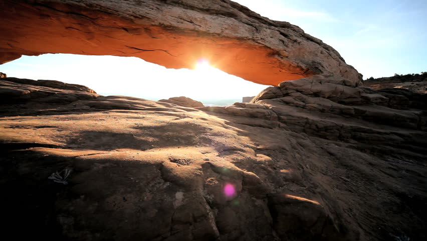 Sunrise seen through the natural opening of the Mesa Arch, Utah