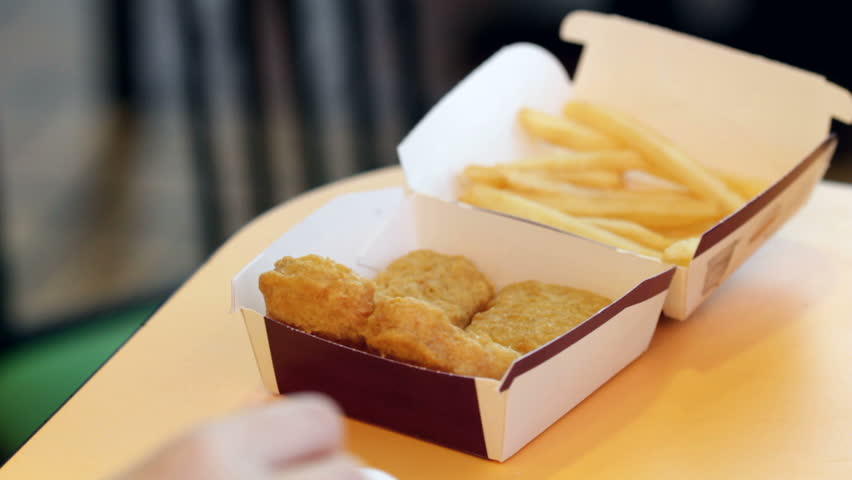 Chicken Nuggets and French Fries eaten by young girl