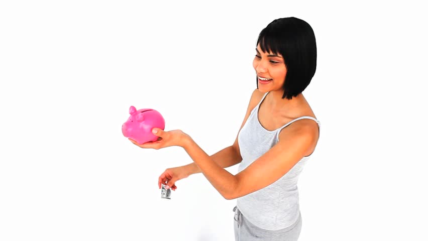 Cute asian woman saving up money in a piggy bank