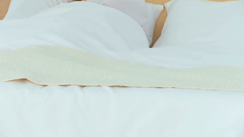 Nurse taking his patient's temperature in the bedroom