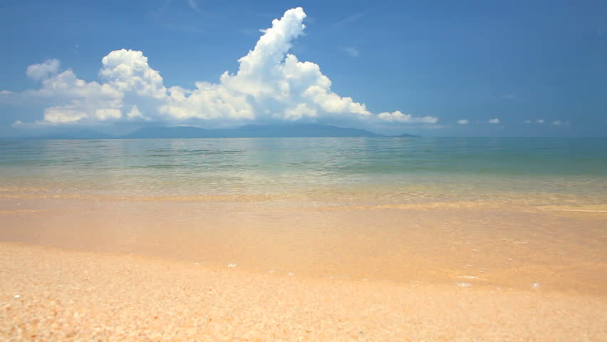 waves landing on sandy beach