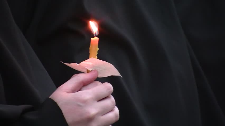 monk with candle in his hand