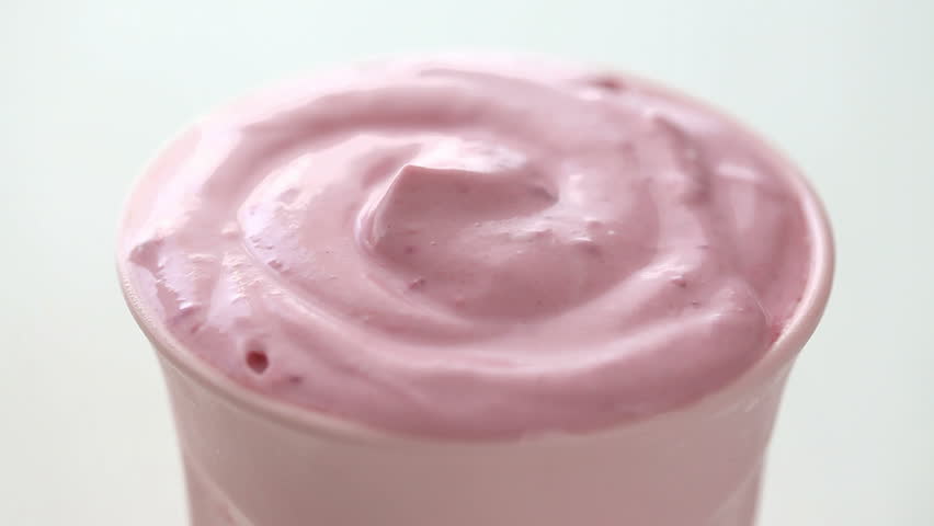 placing raspberry on top of milkshake