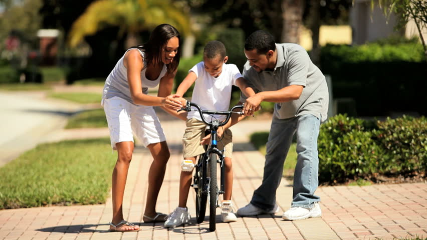African-american Boy Riding His Bicycle in First Time