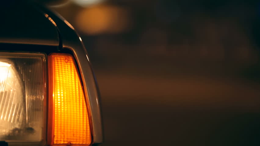 Flashing Car Hazard Lights  on urban road at night