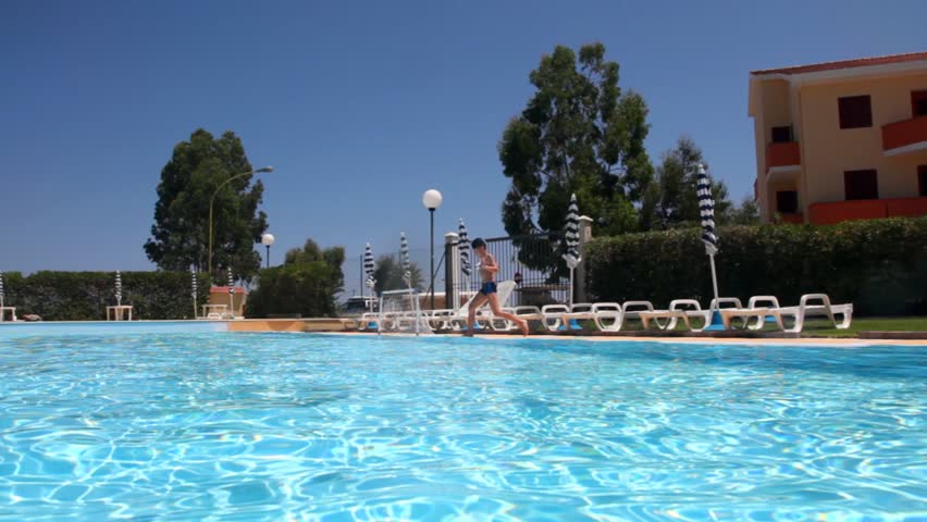 Boy jumped into the pool and threw the ball straight into the camera 
