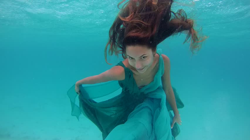 Underwater Young Beautiful Girl In Dress Posing Submerged Under Water