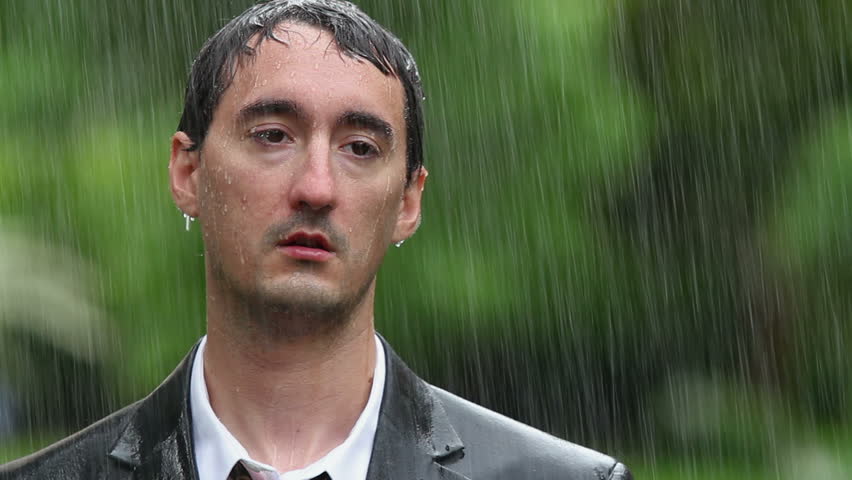 Man wearing suit standing in rain