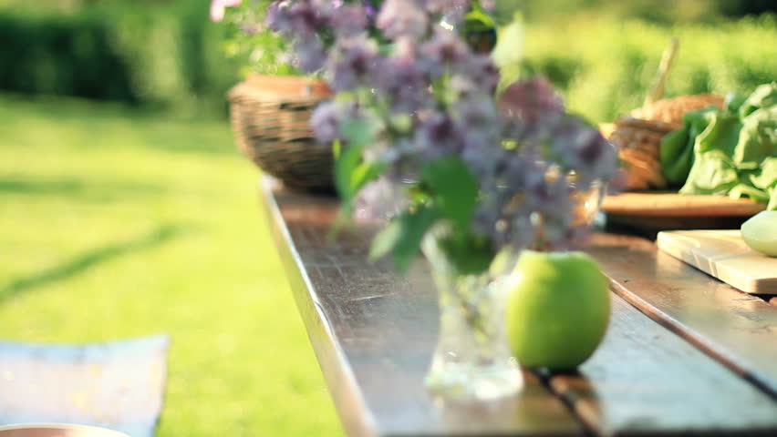 Woman's hands cutting cucumber in the garden, dolly shot 