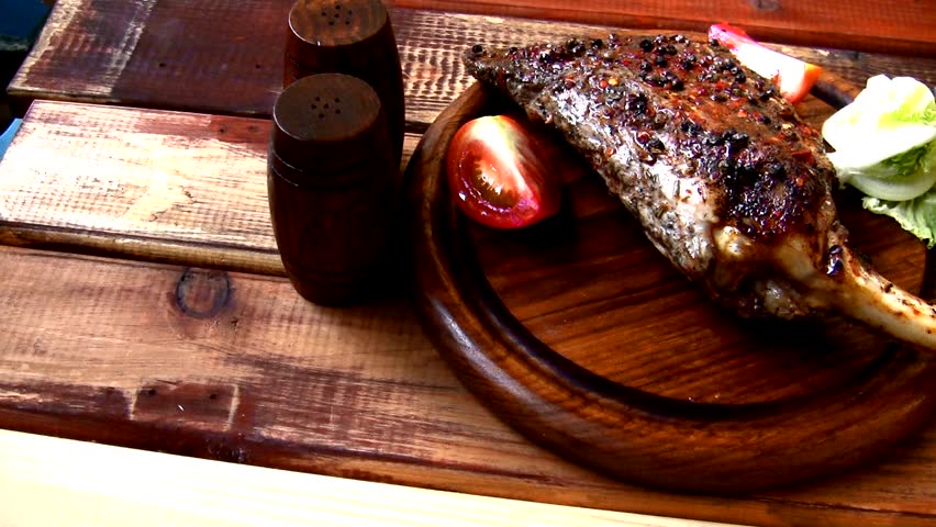 ribs served on wooden table with cutlery