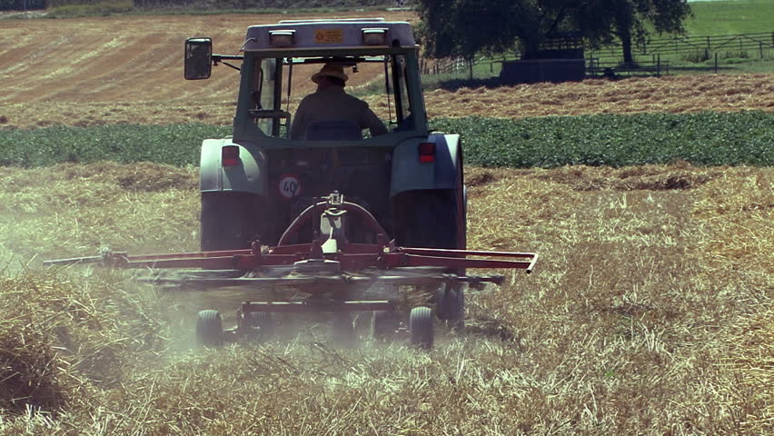 Farmer drives the tractor