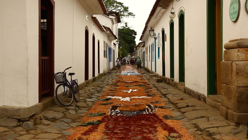cobblestone streets with tapestries made of colored sawdust, pigments, and flowers decorated by Catholics before the procession of Corpus Christi in Paraty, Brazil. 