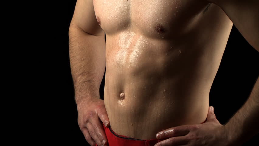 Young man flexing his abs.
