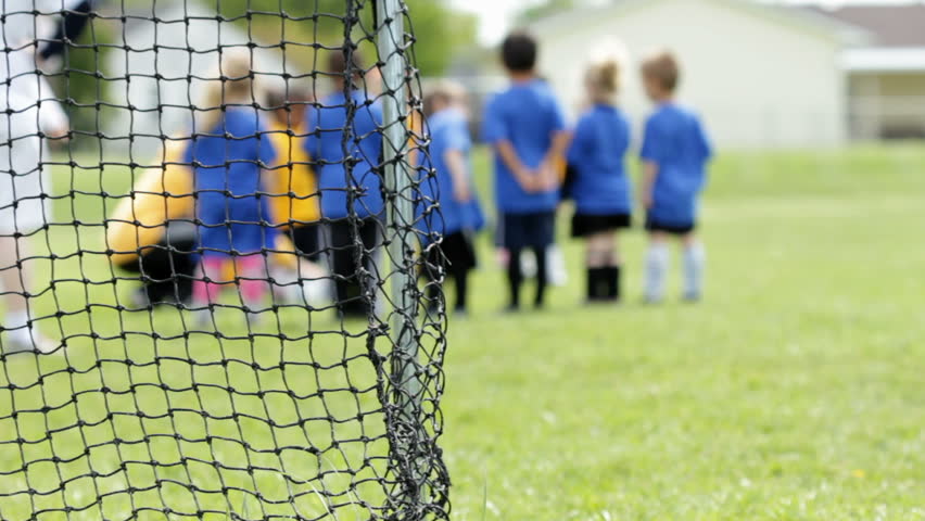 Kids Soccer Game from behind goal net