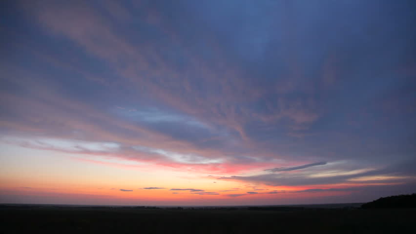 Time lapse sunset over field 