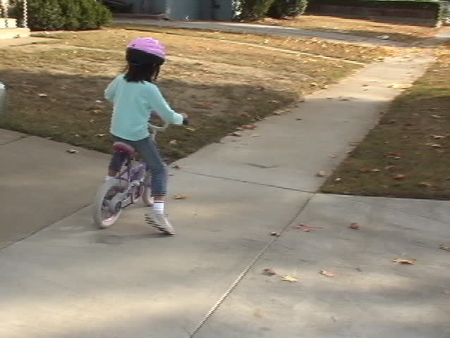girl learning how to bike