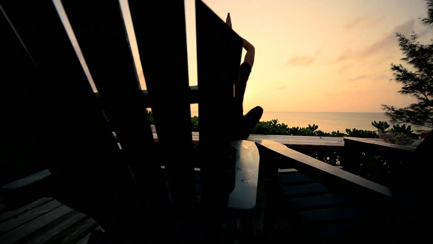 Girl practicing yoga overlooking the ocean in the peace of early morning