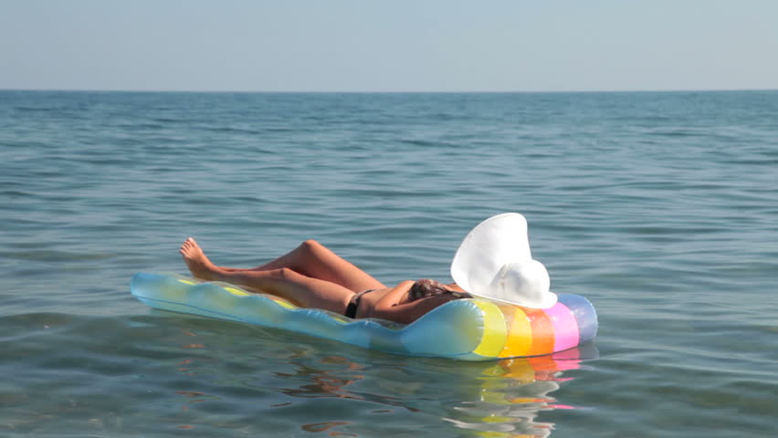 unrecognizable woman in bikini relaxing on raft