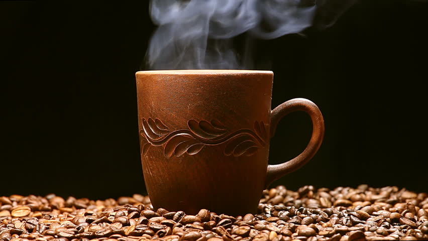 Coffee Being Poured Into Cup On Mound Of Coffee Beans In ...