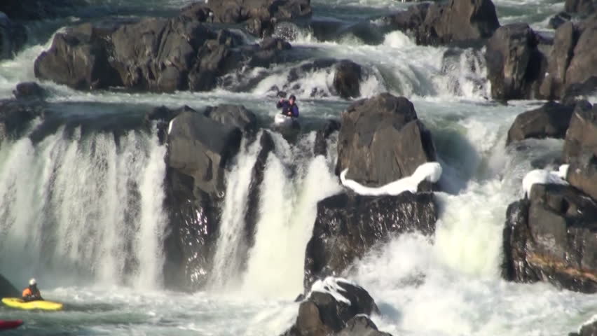 A kayaker plunges off a rapid 