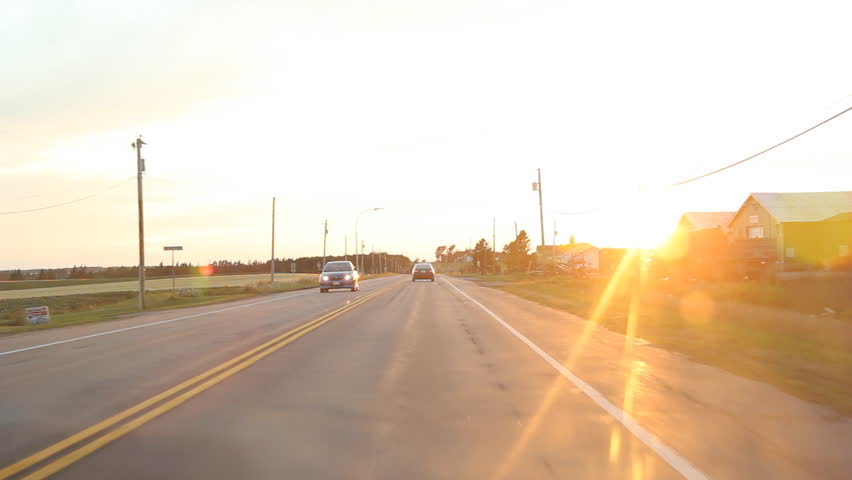 Sunset drive. Driving in the country, with sun going down. Prince Edward Island, Canada. 