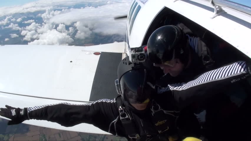 Skydiver in freefall head down been chased by another skydiver  