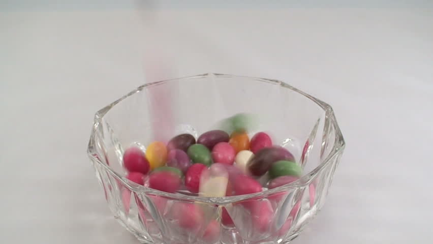 Pouring candies into the bowl 