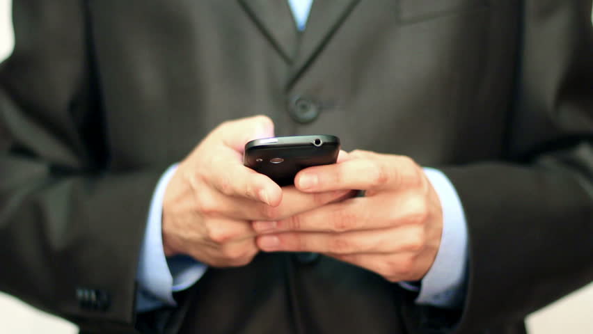 Businessman using mobile phone for text messaging