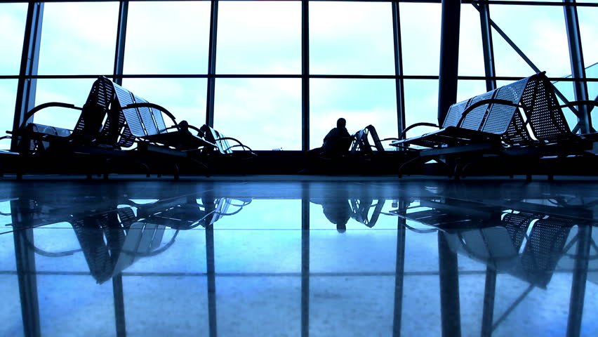 People silhouettes walking at airport space
