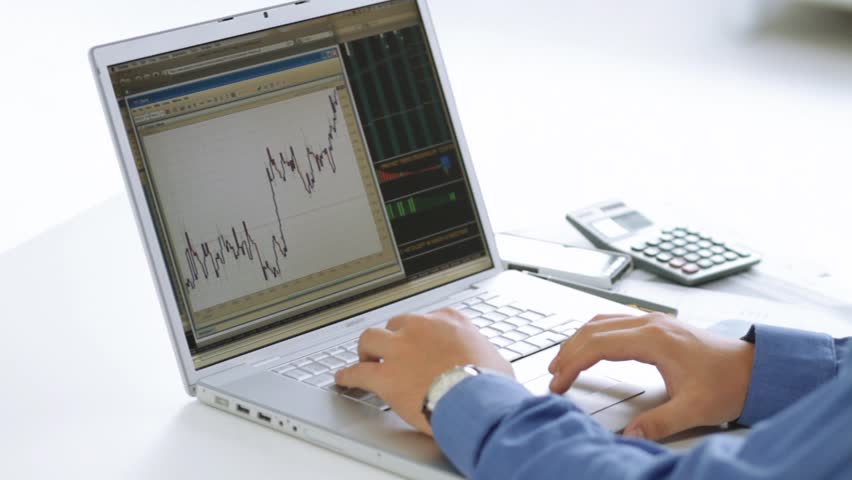 Businessman checking stock market at his laptop computer
