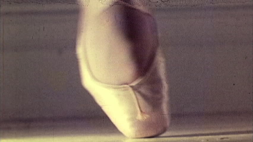 16mm footage close-up of a foot in a ballet pointe shoe.