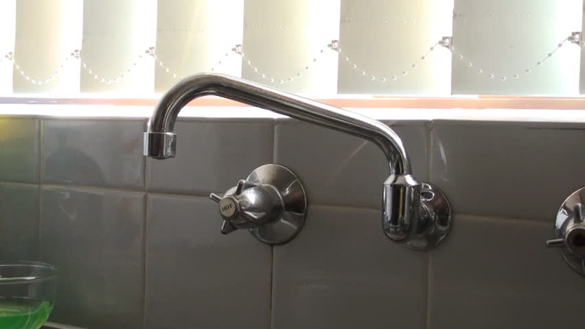 Water dripping from a household kitchen tap and getting wasted