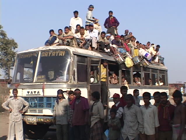 INDIA - CIRCA 2010: Passengers sit atop a crowded bus circa 2010 in India.