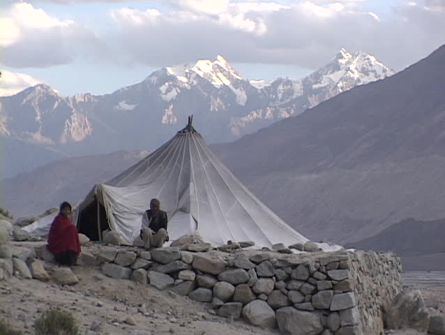 TIBET - CIRCA 2010: An unidentified man and woman sit outside their tent in the Himalayas circa 2010 in Tibet.