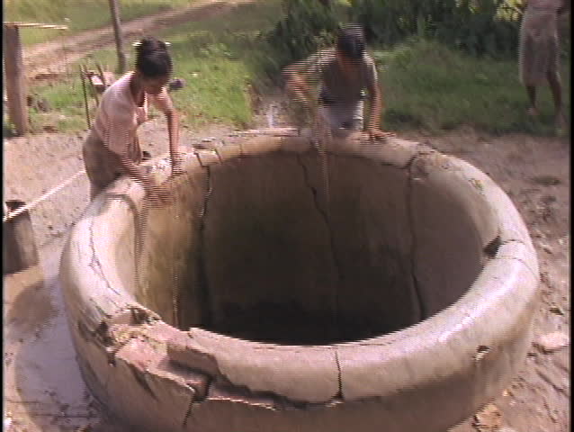 MYANMAR - CIRCA 2010: Women fetch water from a well circa 2010 in Myanmar.