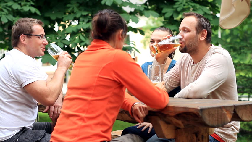 Four friends drinking beer, outdoors