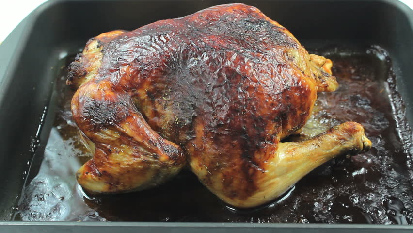 Hot, oven roasted honey and herb chicken cooked in natural juices carved for family dinner. 1080p
