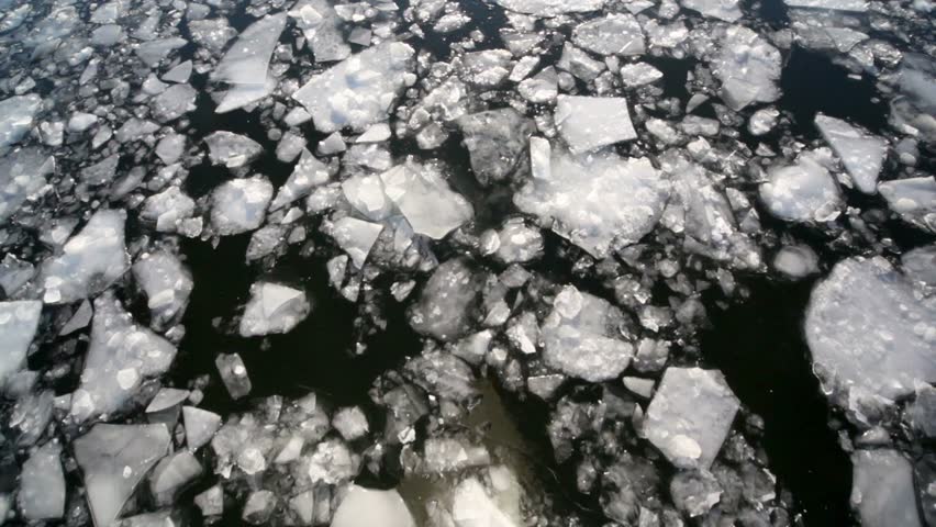 Downward movement of ice cracked, view from boat reflecting in water
