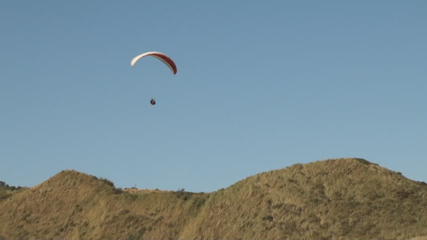 Parasailer sailing over the Dunes along the coast of the province Zeeland in the Netherlands. 