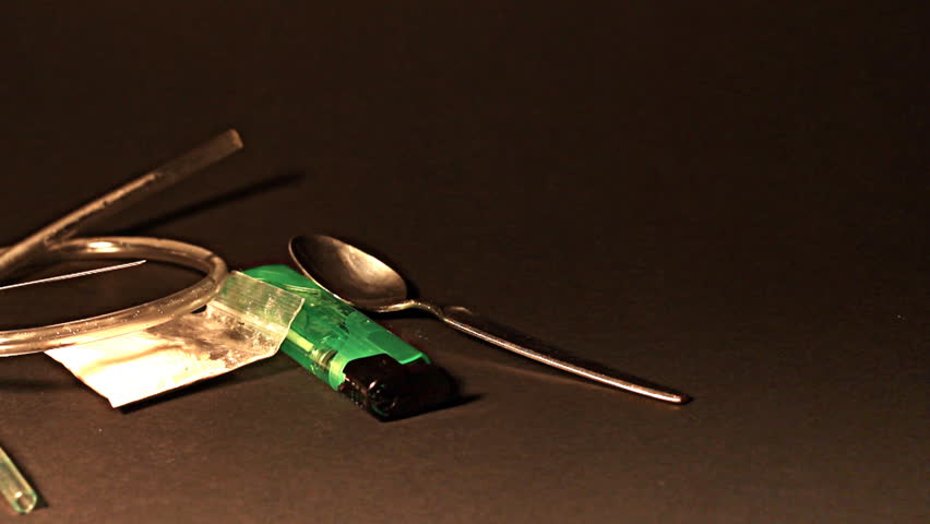 Hard drug - addiction concept. ILLUSTRATION! The white powder is flour before anyone think something else :-)  Studio setup with professional lighting and dolly motion.