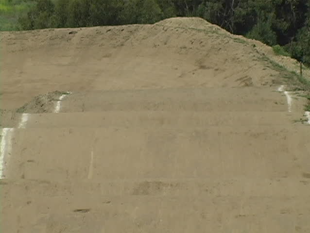 A view of BMX racers coming straight at the camera before turning right.