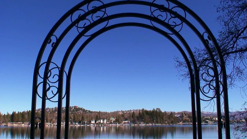 Static shot of Lake Arrowhead through a cast iron arch